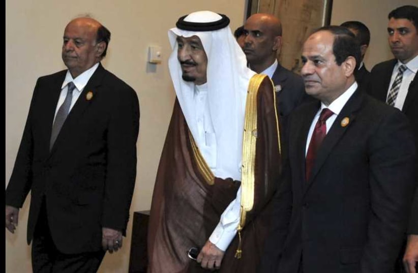 Egyptian President Abdel Fattah al-Sisi (R) stands with Saudi King Salman bin Abdulaziz al-Saud (C), and Yemen's President Abd-Rabbu Mansour Hadi during the 26th Arab Summit in Sharm al-Sheikh, in the South Sinai governorate, south of Cairo, March 28, 2015.  (photo credit: REUTERS)