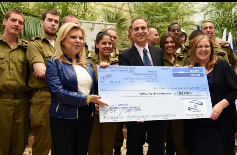 Sara Netanyahu presents NIS 500,000 check for soldiers. (photo credit: AVI HAYOUN)