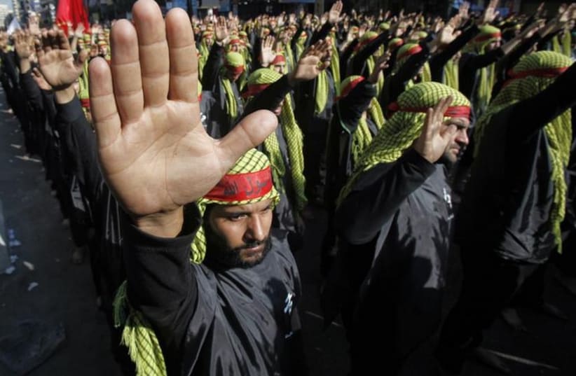 Lebanese Hezbollah supporters gesture as they march during a religious procession to mark Ashura in Beirut's suburbs (photo credit: REUTERS)