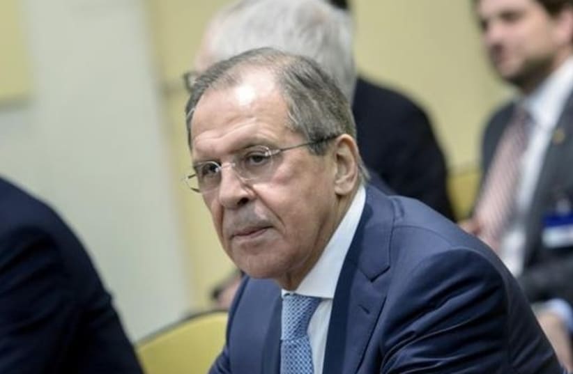 Russian Foreign Minister Sergei Lavrov (C) waits with others for a P5+1 meeting at the Beau Rivage Palace Hotel in Lausanne (photo credit: REUTERS)