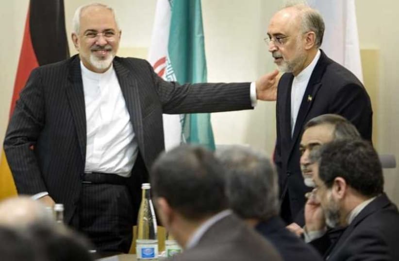 Iranian Foreign Minister Javad Zarif (L) greets Head of Iranian Atomic Energy Organization Ali Akbar Salehi as he arrives for a meeting in Lausanne (photo credit: REUTERS)
