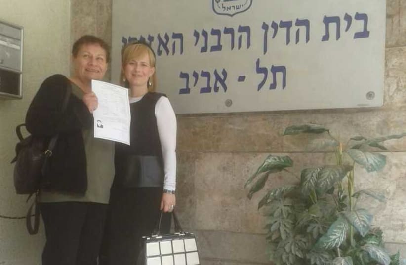 Raya Dinenberg (left) holds her Get, along side her Rabbincial Court Advocate Devorah Brisk outside the Tel Aviv Rabbinical Court (photo credit: YAD L'ISHA)