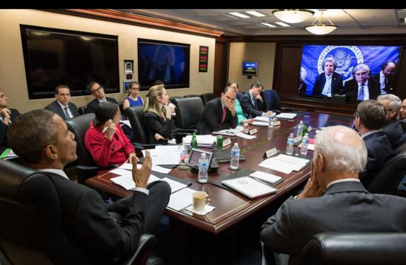 President Barack Obama, Vice President Joe Biden, and White House aides receive an update from Secretary of State John Kerry and Secretary of Energy Ernest Moniz via teleconference in Lausanne (photo credit: WHITE HOUSE)