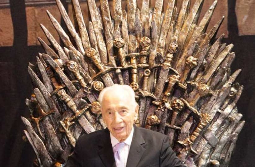 Former president Shimon Peres sits on a replica throne from the hit show 'Game of Thrones' (photo credit: YES)