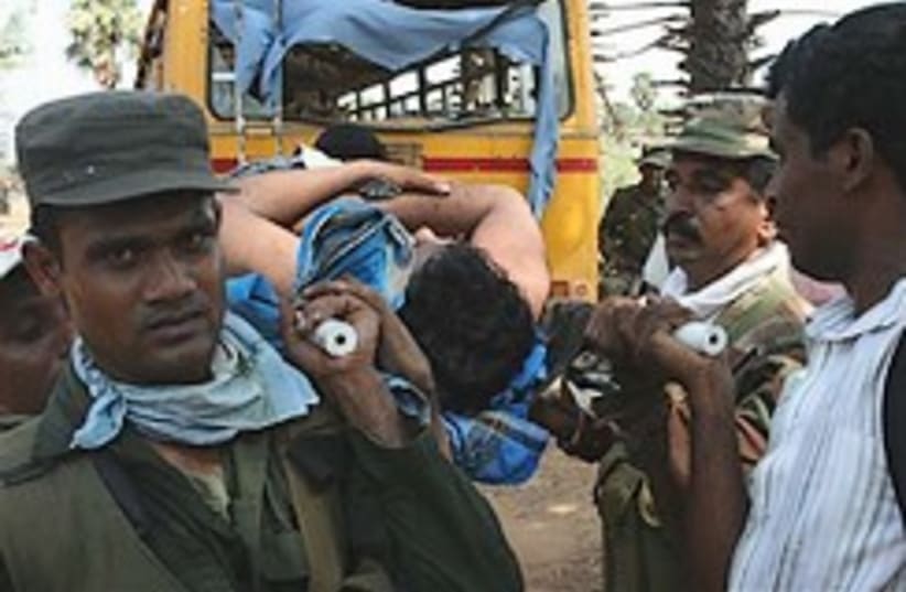 Sri Lankan soldiers evacuate wounded 248 (photo credit: AP)