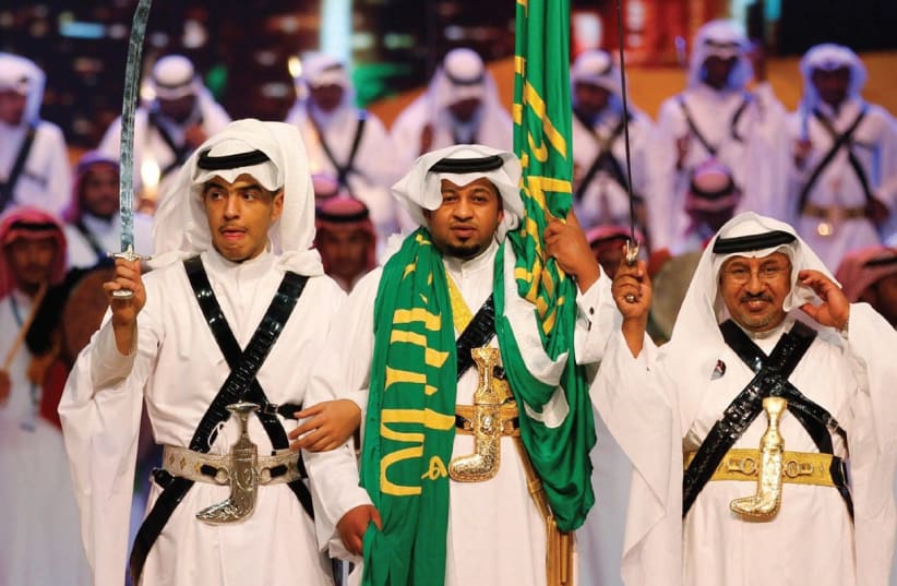 SAUDIS CARRY swords during a sporting event (photo credit: REUTERS)