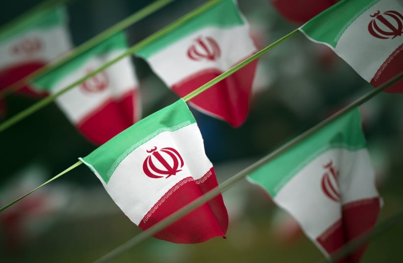 Iran's national flags are seen on a square in Tehran [File] (photo credit: REUTERS)