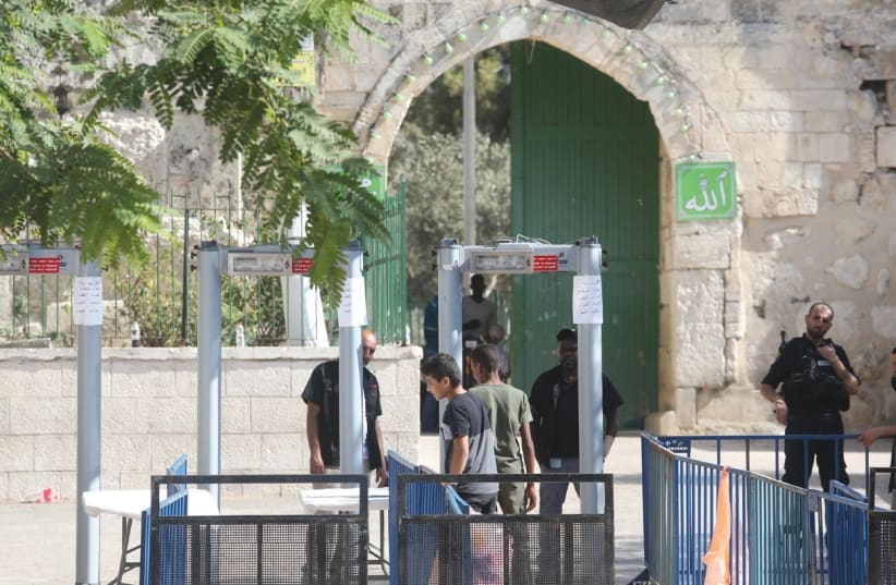 BOYS PASS THROUGH metal detectors just inside the Old City’s Lions’ Gate in the capital yesterday, on their way to enter the Temple Mount. (photo credit: MARC ISRAEL SELLEM/THE JERUSALEM POST)