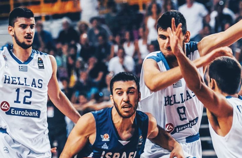 Israel guard Tamir Blatt (center) was shut down by the Greek defense in last night’s 65-56 loss to the hosts in the final of the under-20 European Championship. (photo credit: FIBA EUROPE WEBSITE)