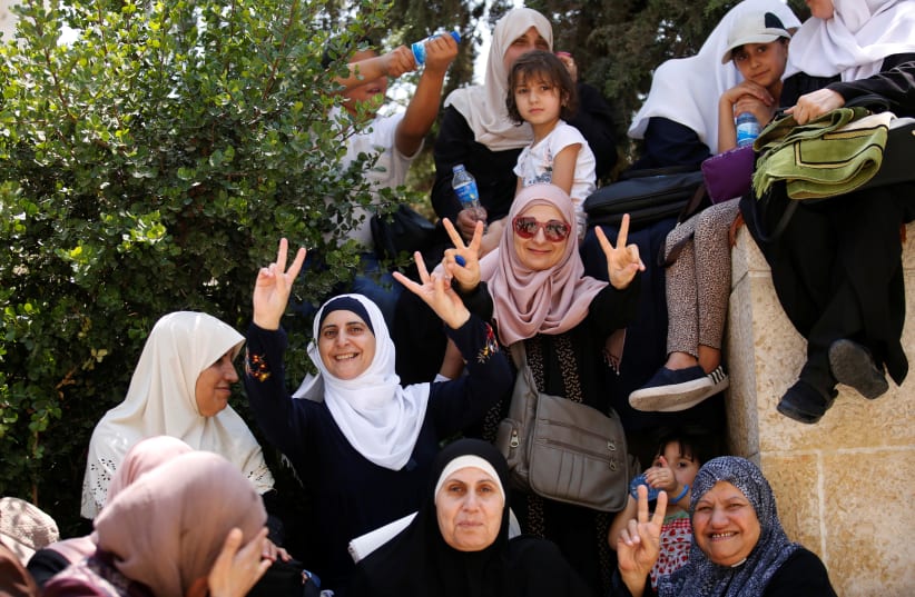 Palestinian women celebrate outside Temple Mount in Jerusalem (photo credit: AMIR COHEN - REUTERS)