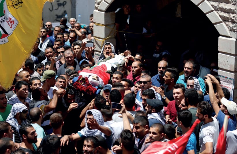 MOURNERS CARRY the body of Palestinian Bara Hamamdah (photo credit: REUTERS)