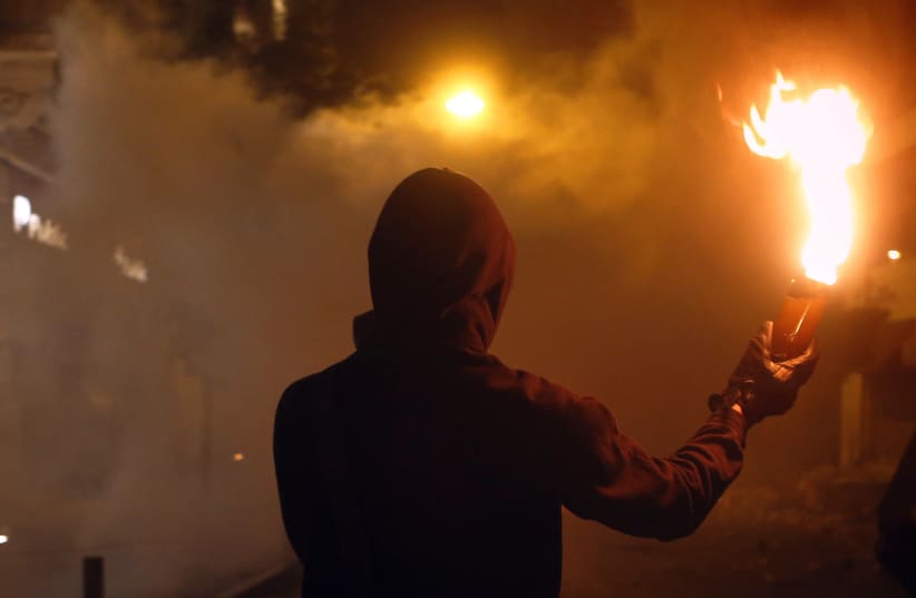 Molotov cocktail in hand (photo credit: YANNIS BEHRAKIS/REUTERS)