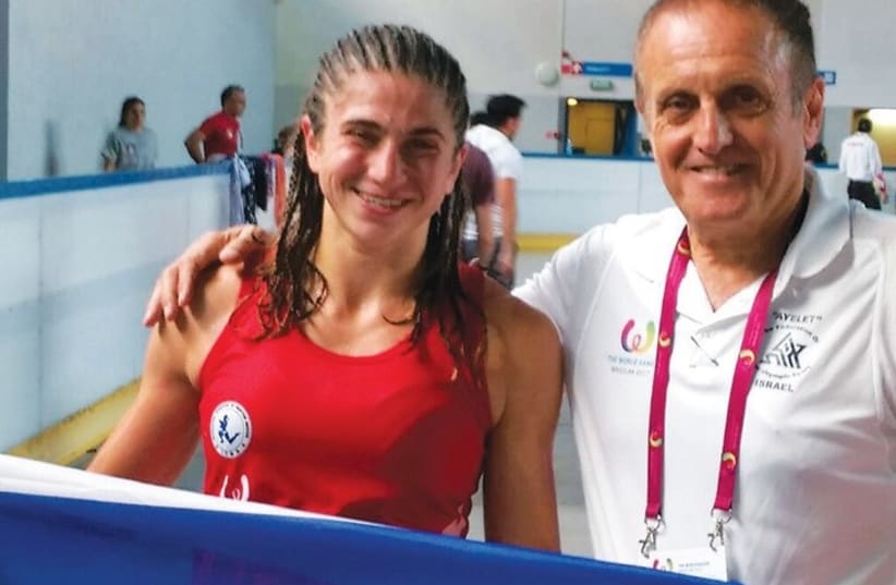 Muaythai fighter Nili Block (left) poses with the Israel flag alongside Dr. Itzik Ben- Melech, who is in charge of Ayelet’s professional department, after winning a bronze medal in the closing day of competition at the World Games yesterday (photo credit: Courtesy)