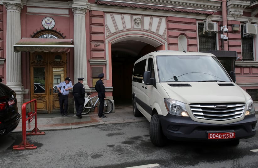 Security officers watch a consulate car entering the US consulate in St. Petersburg, Russia (photo credit: REUTERS/ANTON VAGANOV)