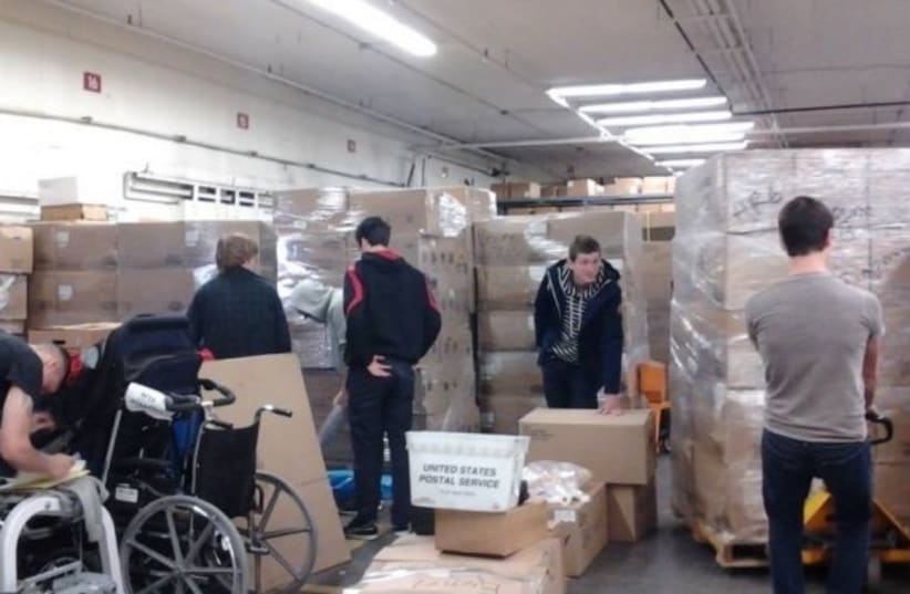 Photos of containers of aid being prepared in the US (photo credit: COURTESY OF THE MUTLIFAITH ALLIANCE)