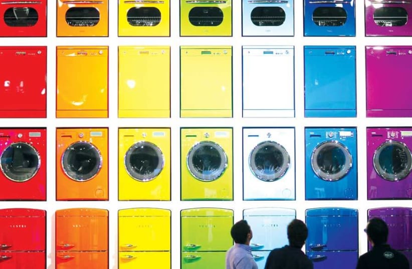 the dishwasher. Twenty years ago (photo credit: HANNIBAL HANSCHKE/REUTERS)