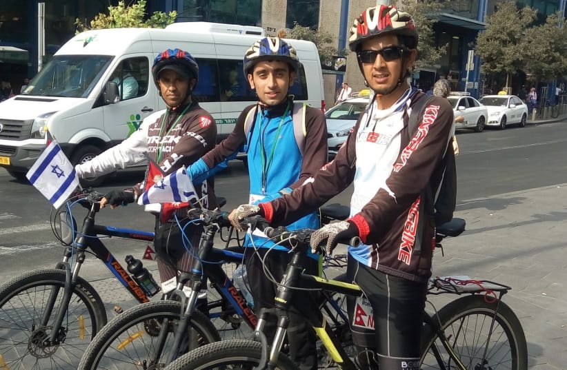 From left: Nirmal Baral, Anish Dhakel and Dilip Chhetri arrive by bicycle at the Jerusalem Central Bus Station last week. (photo credit: YAKIR FELDMAN)