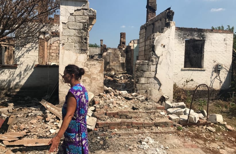 Svetlana Voilova in front of her destroyed apartment in Krasnagorovka (photo credit: SETH J. FRANTZMAN)