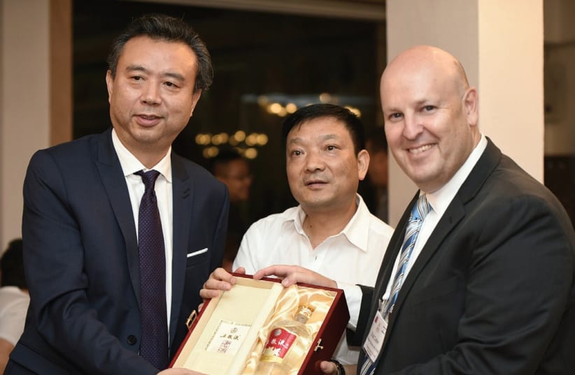FROM LEFT, the chairman of Wuliangye, Li Shuguang; the mayor of Yibin, Du Ziping; and Ohad Cohen, trade commissioner and director of Israel’s Foreign Trade Administration in the Ministry of Economy and Industry. (photo credit: AVI HAYOUN)