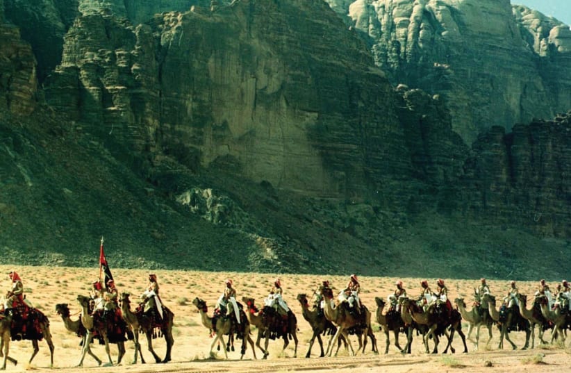 Men on camels near Wadi Rum (photo credit: REUTERS)