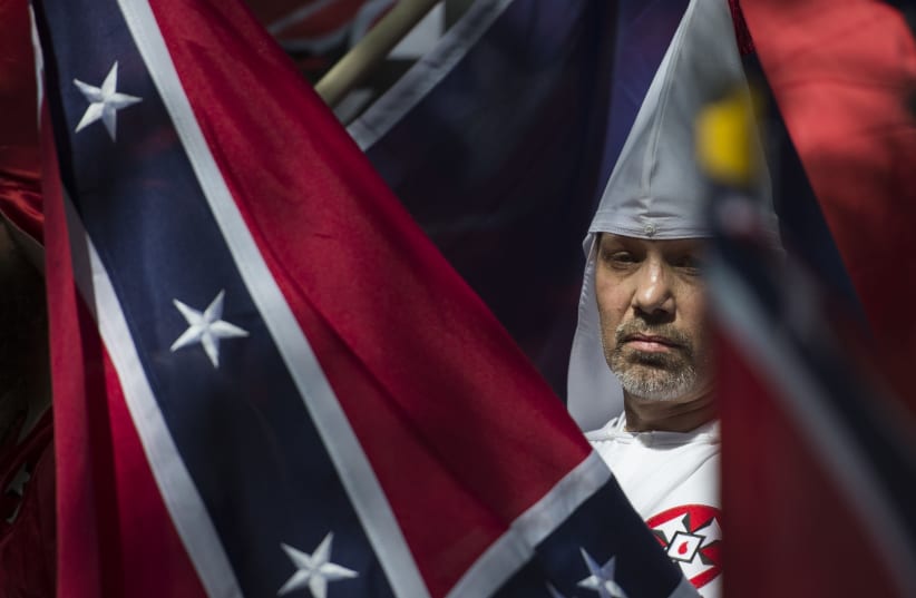 A member of the Ku Klux Klan during a rally in Charlottesville, Virginia, on July 8, 2017.  (photo credit: ANDREW CABALLERO-REYNOLDS / AFP)