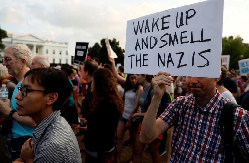 People gather for a vigil in response to the death of a counter-demonstrator at the "Unite the Right" rally in Charlottesville, outside the White House in Washington, U.S. August 13, 2017.  (photo credit: JONATHAN ERNST / REUTERS)