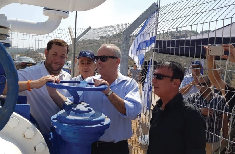 SAMARIA REGIONAL COUNCIL head Yossi Dagan (left), Infrastructure Minister Yuval Steinitz (center) and Civil Administration officer Benny Elbaz inaugurate a 13-km. water pipeline in Samaria on Monday. (photo credit: SAMARIA REGIONAL COUNCIL)