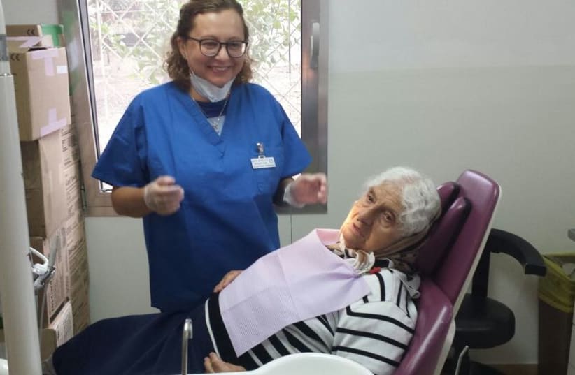 A patient recieves free dentures from Dental Volunteers for Israel (photo credit: Courtesy)