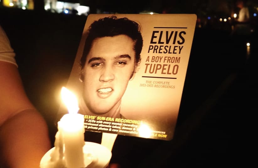 Elvis Presley fans from around the world held a candlelight vigil outside his Memphis home on Tuesday to mark the 40th anniversary of the singer’s death.  Presley’s daughter Lisa Marie joined the vigil and lit candles for fans who gathered at the Graceland estate where tributes to the King of Rock ‘ (photo credit: REUTERS)