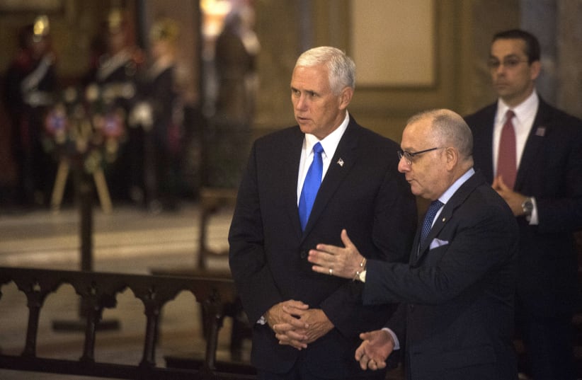 Vice President Mike Pence, left, with Argentine Foreign Minister Jorge Faurie during a wreath-laying ceremony at the Metropolitan cathedral in Buenos Aires. (photo credit: AFP PHOTO)