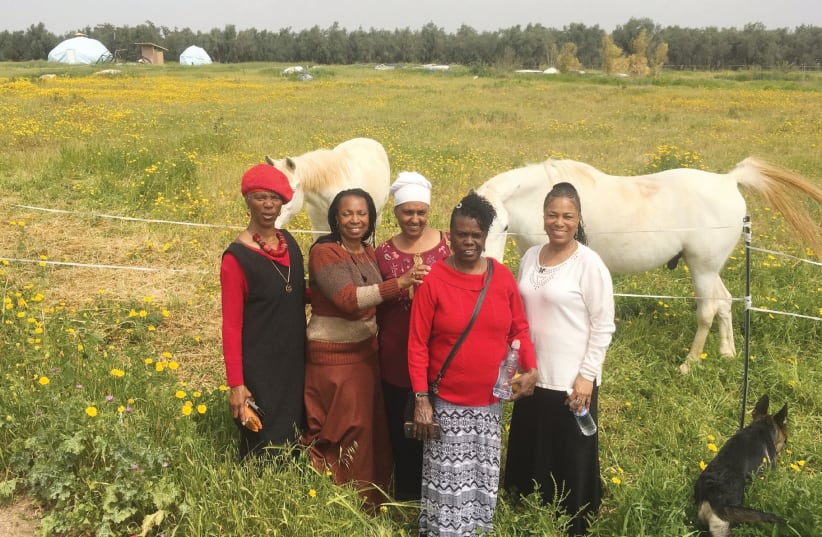 Members of the Black Israelite community of Dimona, who came to stay at Solomon’s Sanctuary for a few days, visiting the StayTru farm. (photo credit: KEVIN SCHLOSSER)