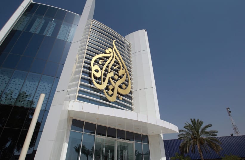 The Al-Jazeera Media Network logo is seen on its headquarters building in Doha, Qatar. (photo credit: REUTERS)