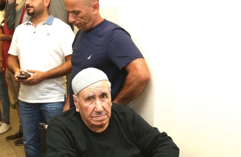 AYOUB SHAMASNEH (seated in wheelchair) and his son Mohammad Shamasneh (directly behind) wait at the Jerusalem Magistrate’s Court last Thursday. (photo credit: MARC ISRAEL SELLEM/THE JERUSALEM POST)