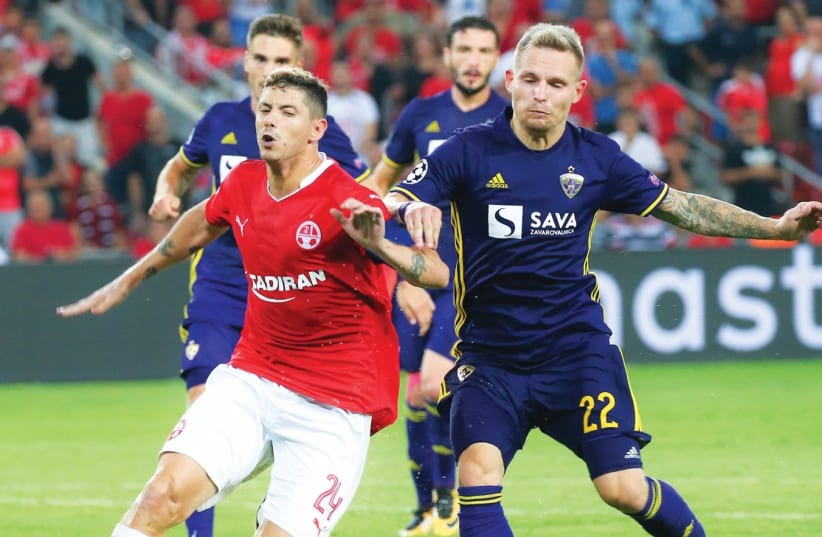 Hapoel Beersheba midfielder Maor Melikson (left) is set to be handled roughly by Maribor players, including Martin Milec, once more tonight when the teams clash in the second leg of the Champions League playoffs in Slovenia. (photo credit: DANNY MARON)