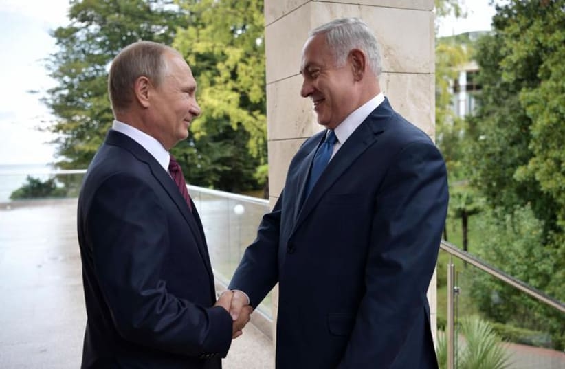 Russian President Vladimir Putin (L) welcomes Israeli Prime Minister Benjamin Netanyahu in Sochi, Russia August 23, 2017. (photo credit: SPUTNIK/ALEXEI NIKOLSKY/KREMLIN VIA REUTERS)