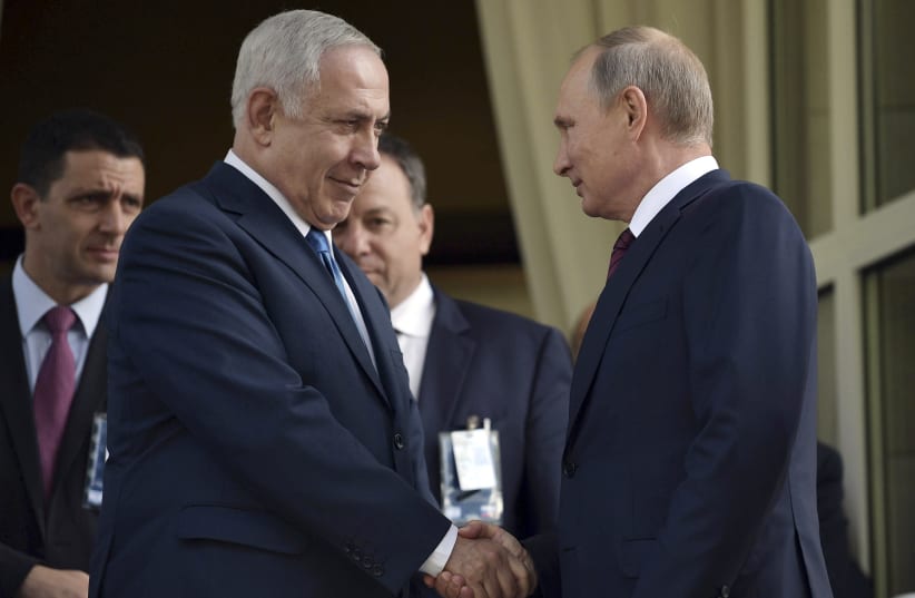 Russian President Vladimir Putin (R) shakes hands with Israeli Prime Minister Benjamin Netanyahu during a meeting in Sochi, Russia August 23, 2017. (photo credit: SPUTNIK/ALEXEI NIKOLSKY/KREMLIN VIA REUTERS)