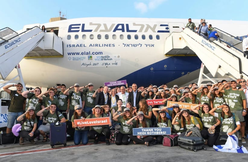 A group of new olim pose after arriving in Israel (photo credit: SHAHAR AZRAN)