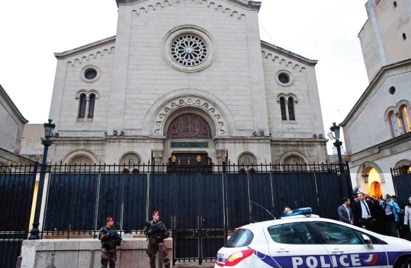 SOLDIERS AND a police car stand in front of a synagogue in Marseille, France. (photo credit: REUTERS)