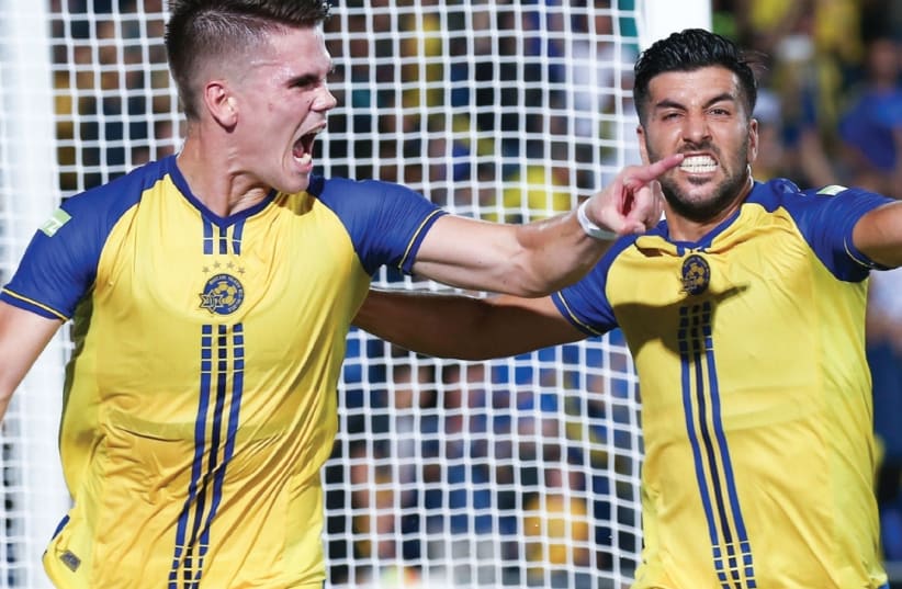 Maccabi Tel Aviv striker Vidar Orn Kjartansson (left) celebrates with teammate Avi Rikan after scoring in last night’s 2-2 draw against Altach in Netanya which sent the yellow-and-blue through to the Europa League group stage. (photo credit: DANNY MAROM)