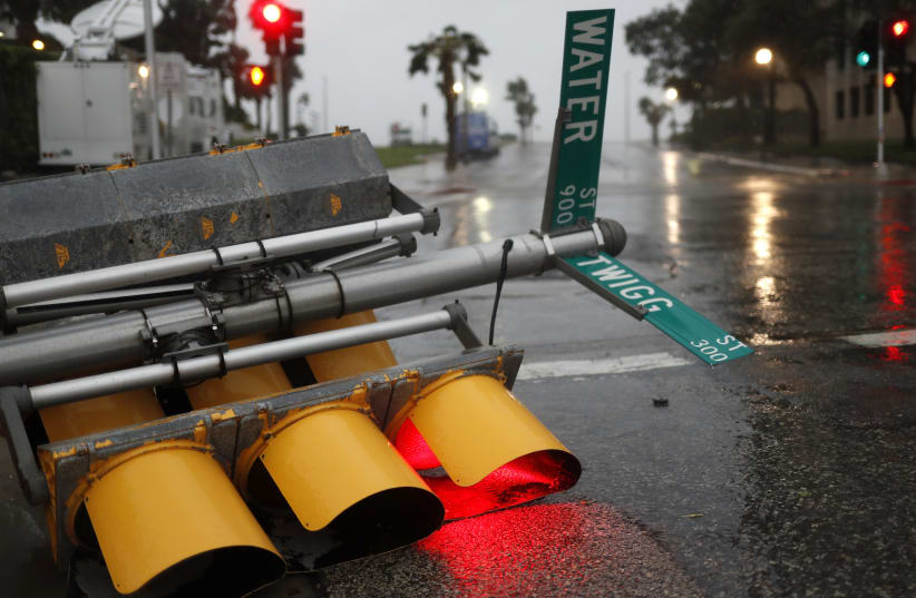 Traffic lights lie on a street after being knocked down, as Hurricane Harvey approaches in Corpus Christi, Texas, US August 25, 2017.  (photo credit: REUTERS)