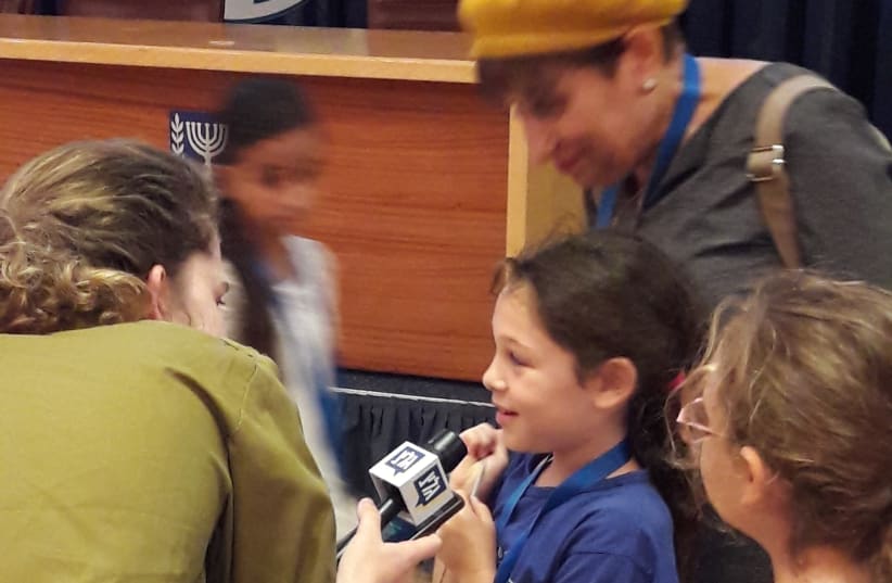 A student is interviewed at the Foreign Ministry's open day for kids, August 2017 (photo credit: HERB KEINON)
