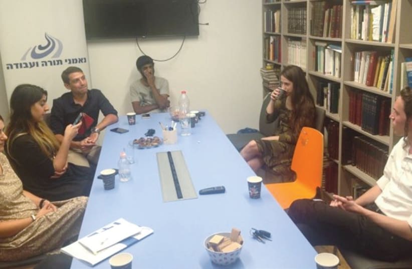 PEOPLE HOLD a discussion at the office of Ne’emanei Torah Va’Avodah, a religious-Zionist lobbying group working to combine ‘Torah and science’ in education (photo credit: COURTESY NE’EMANEI TORAH VA’AVODAH)