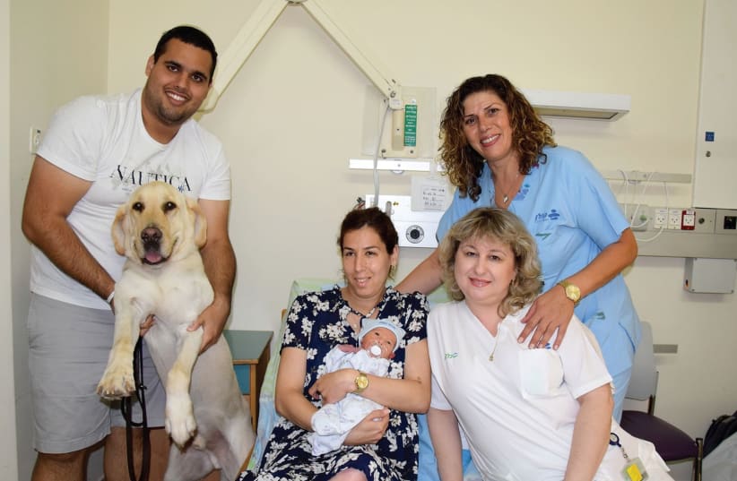 BAT EL and Sagi with their newborn baby and guide dog, Neon, at the Kaplan Medical Center. (photo credit: KAPLAN MEDICAL CENTER)