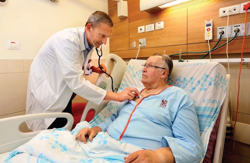 PROF. GIL BOLOTON examines patient Robert McClaken at Haifa’s Rambam Medical Center (photo credit: PIOTR FLITR)