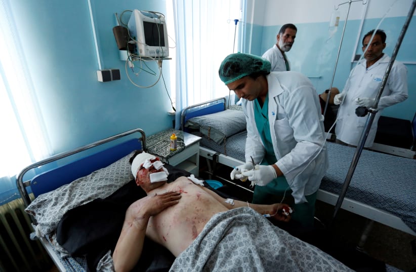 An injured man receives treatment after a suicide attack, inside a hospital in Kabul, Afghanistan. (photo credit: REUTERS)
