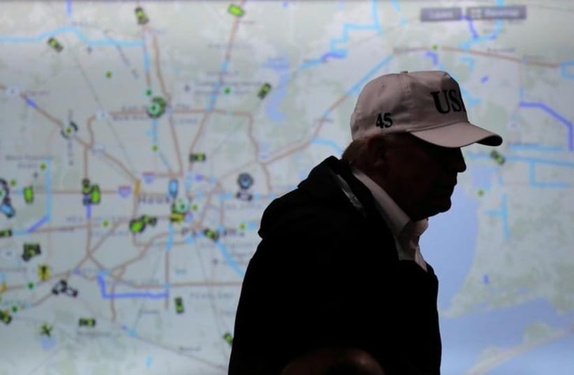 US President Donald Trump walks in front of a map of Houston during a briefing on Tropical Storm Harvey relief efforts at the Texas Department of Public Safety Emergency Operations Center in Austin, Texas, US, August 29, 2017.  (photo credit: REUTERS/CARLOS BARRIA)