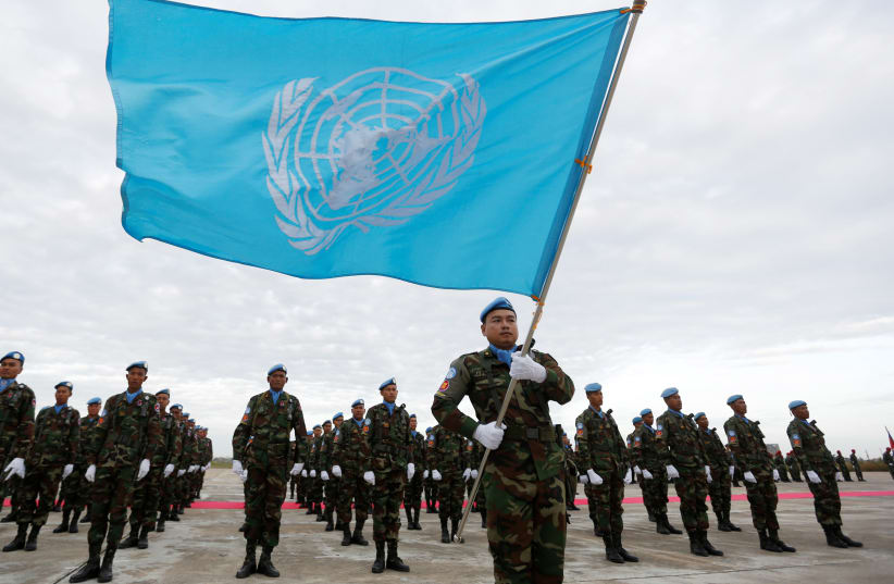 Cambodian soldiers serving with the United Nations Interim Force in Lebanon (UNIFIL), stand for their National Anthem during a send-off ceremony at Pochentong Air Base in Phnom Penh January 4, 2017.  (photo credit: REUTERS)