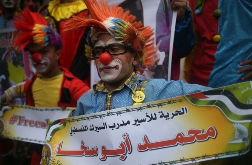 Mohammad Abu Sakha's fellow clowns demontrasted in solidarity with their detained colleague (photo credit: AFP PHOTO/ MOHAMMED ABED)