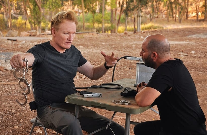 Conan O’Brien films a skit with Israeli actor Lior Raz on the set of ‘Fauda.’ (photo credit: YORAM SHAPIR)