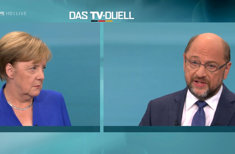 A screen shows the TV debate between German Chancellor Angela Merkel of the Christian Democratic Union (CDU) and her challenger Germany's Social Democratic Party SPD candidate for chancellor Martin Schulz in Berlin, Germany (photo credit: HANDOUT/REUTERS)